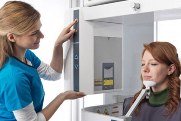 A dental client receiving jaw and skull imaging through a 3D Cone Beam Scanner